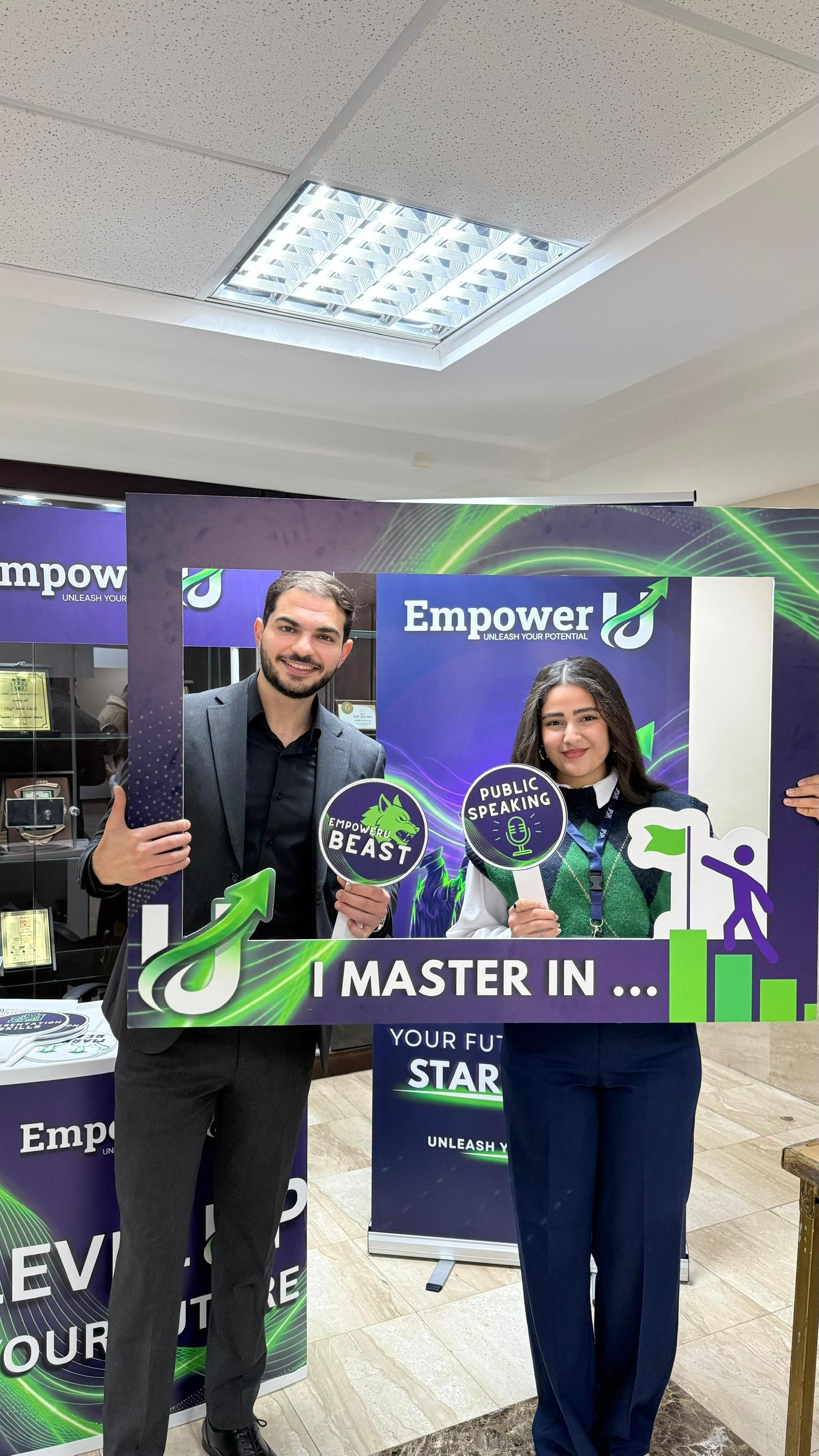 Two Wave One participants holding the EmpowerU public speaking photo frame